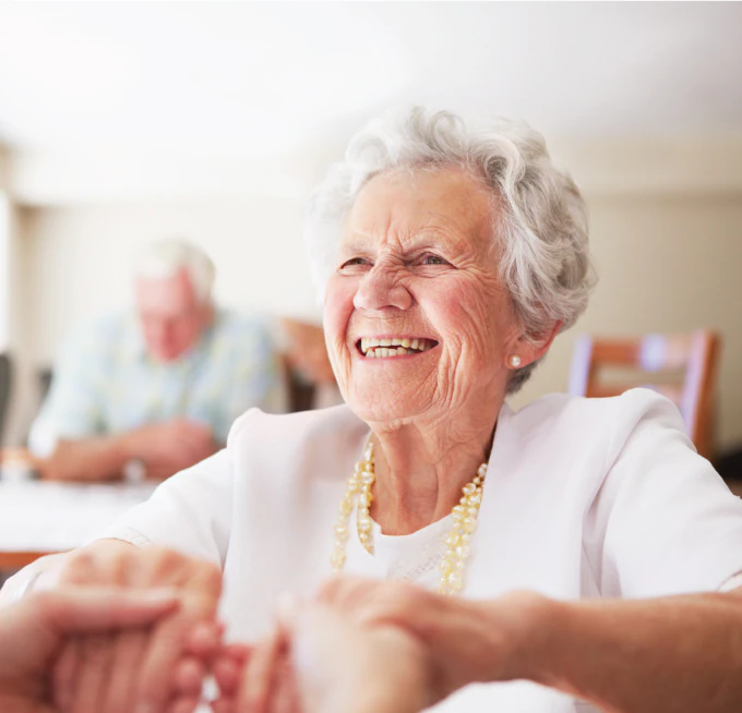 senior-woman-holding-hands senior woman holding the hands of an employee