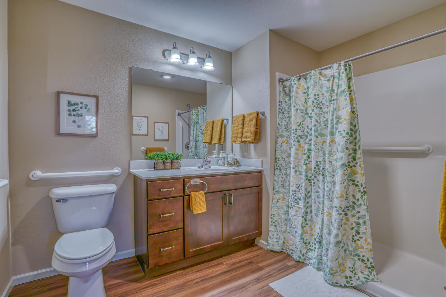 Spacious and accessible bathroom in a senior living unit with modern fixtures.