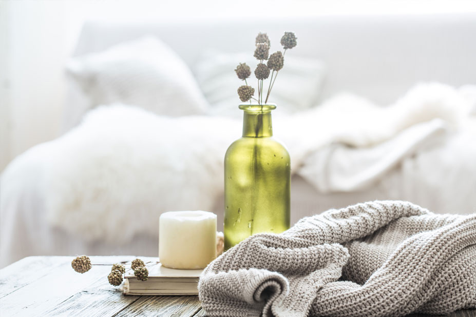 cozy blanket with book and candle