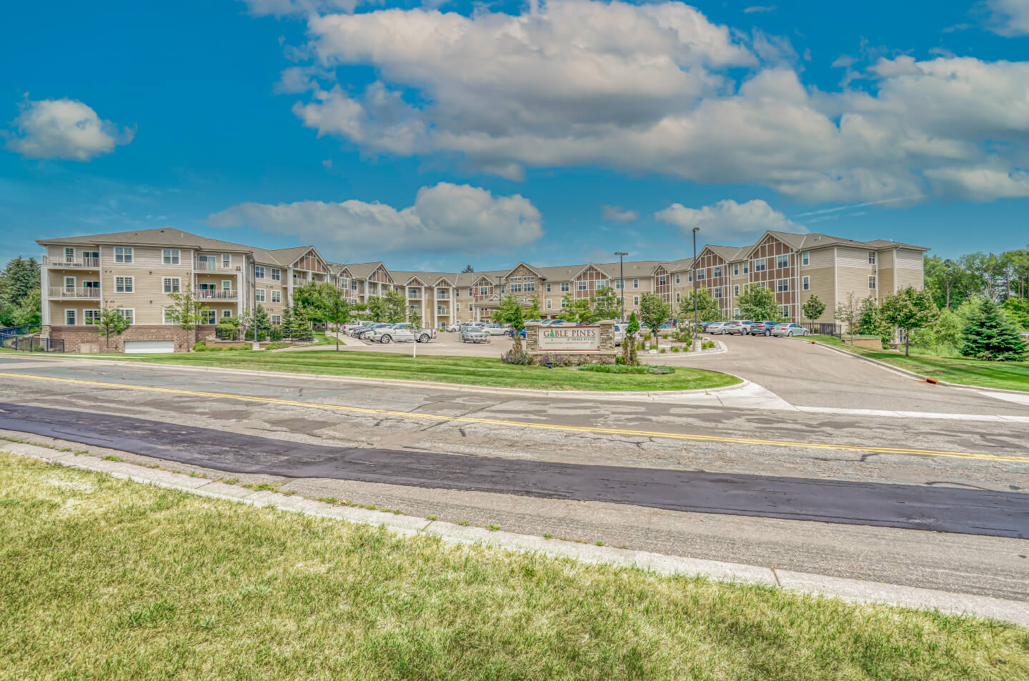 Exterior view of Gable Pines with multiple units, landscaped surroundings, and a welcoming entrance.