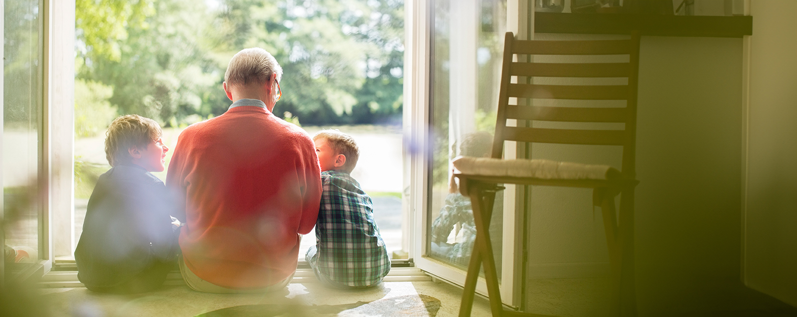 senior man sitting with young kids