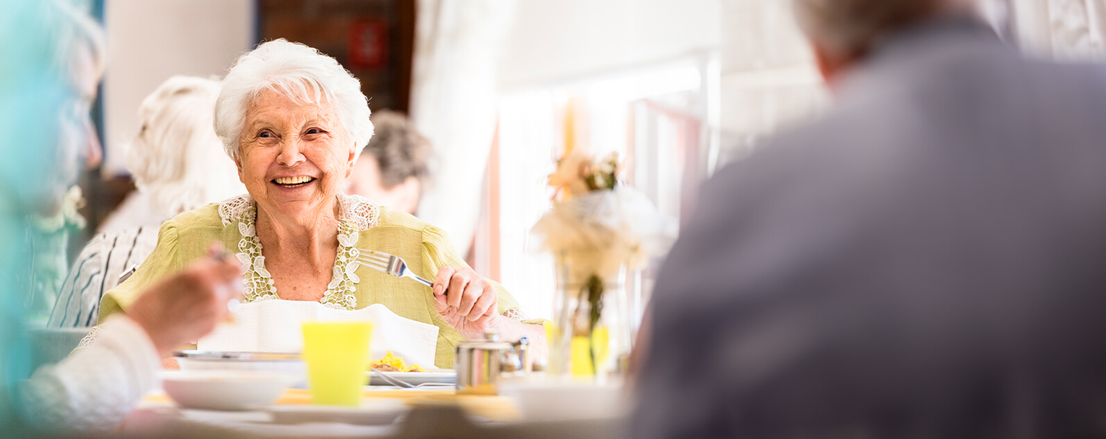 senior woman dining with friends