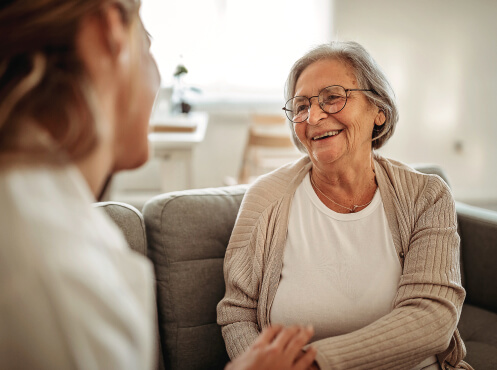 senior woman talking to staff member